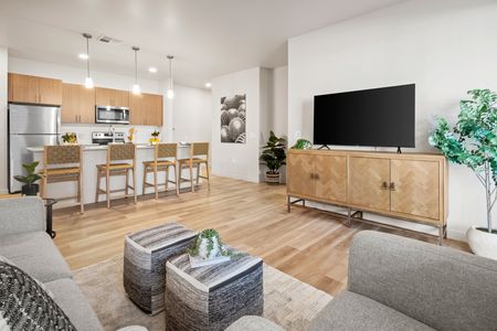 Pet-Friendly Apartments in Goodyear AZ - Acero Roosevelt - A Bright And Spacious Living Toom With Wood-Style Flooring, White Walls, And A Wide Open Floor Plan With Plenty Of Room For Furniture And Entertainment Options