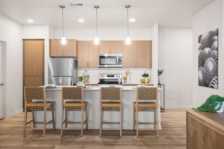 Goodyear, AZ Apartments - Acero Roosevelt - A Bright And Updated Kitchen With White Countertops, Stainless Steel Appliances, And Light Wood Cabinetry