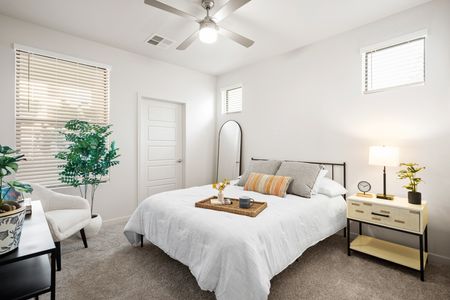 Goodyear Apartments - Acero Roosevelt - A Bright And Spacious Bedroom With White Walls, Plush Carpeting, A Ceiling Fan, Multiple Windows, And Room For A Full Sized Bed