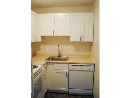 Kitchen with white appliances at Princeton Commons | Apartments in Claremont, NH