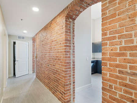 Archway in brick wall going from hallway to kitchen in apartment at Washington Mill 240 apartments in Lawrence, KA.