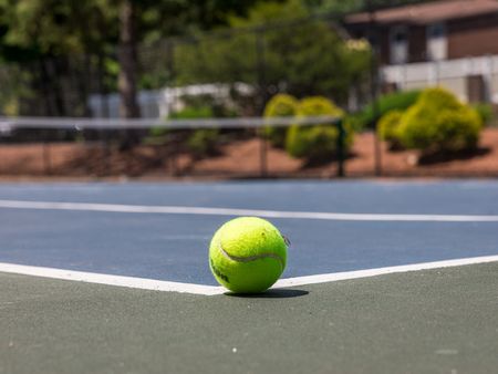 Tennis Court with close-up of green tennis ball  at Pheasant Run Apartments | Nashua NH Apartments