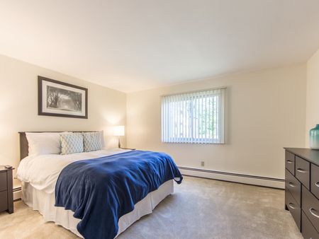 Bedroom with carpet  in apartment at Pheasant Run  | Nashua NH Apartments