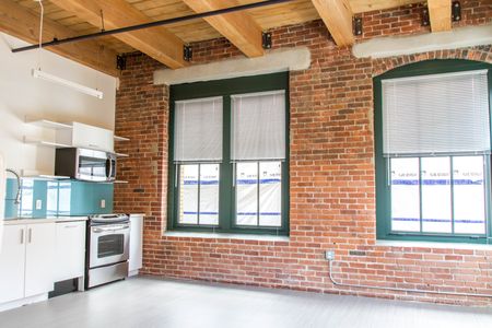 High ceilings with exposed beams, interior exposed brick wall |  381 Congress Lofts | Apartments in Downtown Boston