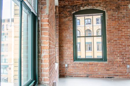 Charming elegant brick interior walls with large windows | 381 Congress Lofts | Apartments in Downtown Boston