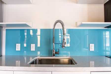 Vibrant blue backsplash adds a pop of color behind kitchen counters |381 Congress Lofts | Apartments For Rent in Boston