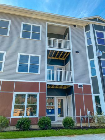 Exterior of apartments showing balconies in annex apartment at Dover Apartments in Dover, NH.