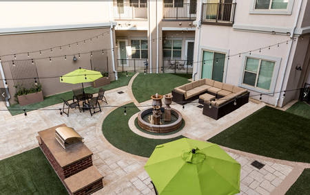 View of Outdoor Lounge, Showing Picnic Areas, Outdoor Furniture, and Grill at The Melrose Apartments