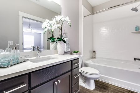 View of Renovated Apartment Interiors, Showing Bathroom With Garden Tub, Plank Flooring, and Single Vanity at Cottonwood Reserve Apartments