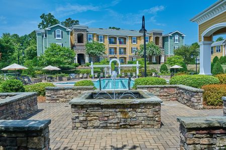 View of Resort Style Pool, Showing Brick Fountain, Buildings, Pergola, and Outdoor Furniture at Cottonwood Reserve Apartments