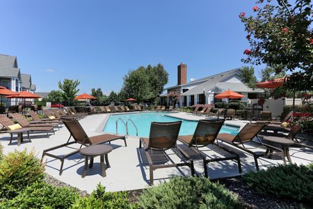 View of Resort-Style Pool, Showing Loungers, Sundeck, and Landscaping at Cason Estates Apartments