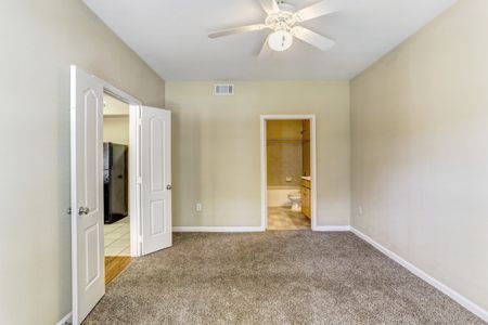 View of Bedroom, Showing Double Door Entry, Carpet, Ceiling Fan and Attached Bathroom at Cason Estates Apartments