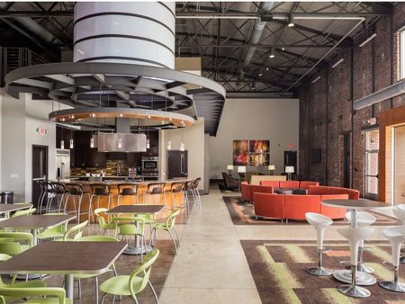 View of Clubroom, Showing Demonstration Kitchen and Seating Areas at The Melrose Apartments