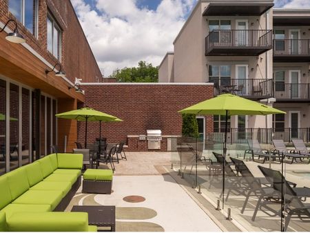 View of Outdoor Lounge, Showing Outdoor Furniture, Loungers, Picnic Areas, and Grill at The Melrose Apartments