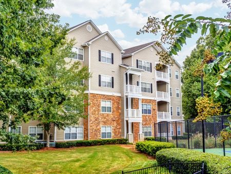 View of Building Exterior, Showing Patio, Balconies, Landscaping, and View of Tennis Court at Summer Park Apartments