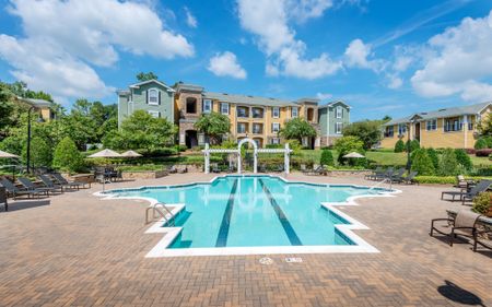 View of Resort Style Pool, Showing Seating With Umbrellas, Buildings, and Pergola at Cottonwood Reserve Apartments