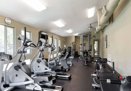 View of Fitness Center, Showing Cardio Machines, Cable Machines, and TVs at Fox Point in Old Farm Apartments