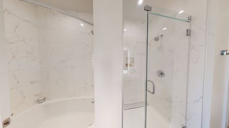Spa-like retreat with glass enclosed shower and large soaking bath
