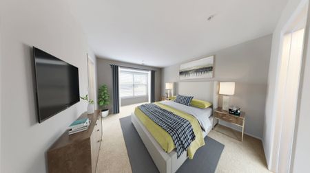 Bedroom with large windows and plush carpeting Countertops and White Cabinetry at Alister Town Center Columbia apartments.