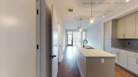 Thoughtfully-Designed Open Layouts - kitchen with white cabinetry. in a Modera Old Ivy apartment.
