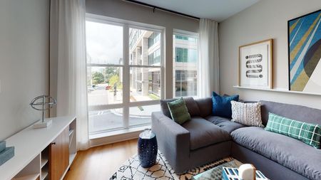 Living room with large windows and city views at Modera Old Ivy in Atlanta Georgia