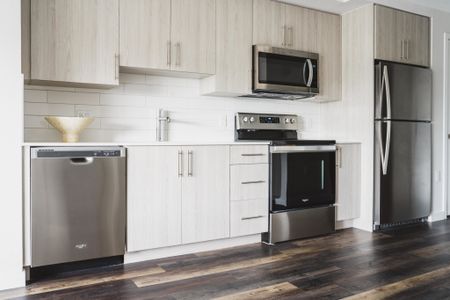 high-end kitchen with stainless steel appliances at Modera Skylar apartments homes miami florida