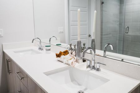 spa-like bathroom with dual vanities at Modera Skylar apartments homes miami florida