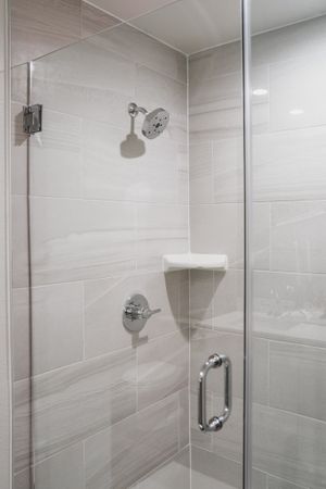 shower with glass enclosure and high-end fixtures at Modera Skylar apartments homes miami florida