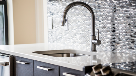 Kitchen faucet with pull down spray head in an apartment at Modera Mosaic in Fairfax, VA.