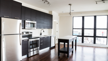 Brightly lit open concept kitchen and living space in an apartment at Modera Mosaic.