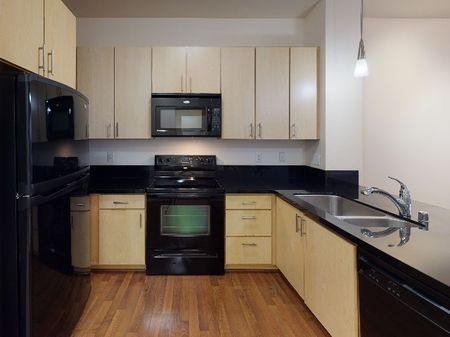 Open concept kitchen with black appliances