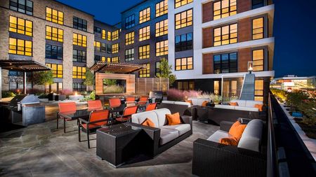 Elevated Deck with Seating and Grills at Modera Mosaic apartments in Fairfax, VA.