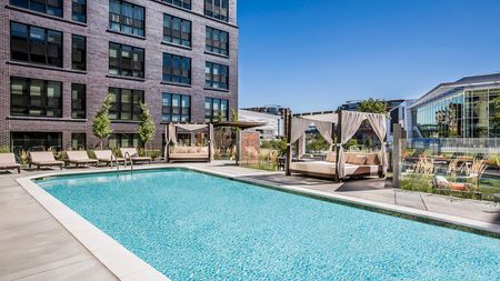 Resort-Style Pool and Sundeck with Cabanas at Modera Mosaic apartments in Fairfax, VA.
