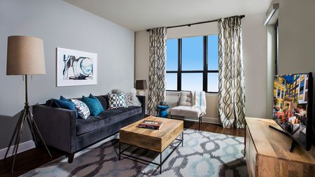 Modern Living Area with Oversized Windows in an apartment at Modera Mosaic.