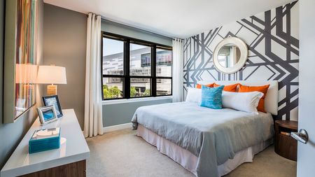 Spacious Primary Suite with Creative Finishes and King Size Bed in an apartment at Modera Mosaic.