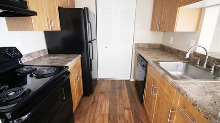 Classic Style Kitchen featuring Black Appliances and Open Concept at Alister Town Center Columbia apartments.
