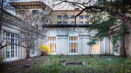 Pre-renovation courtyard featuring original architectural features with gorgeous windows
