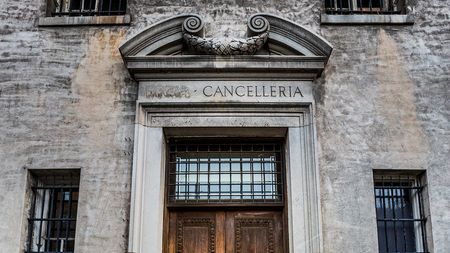 Exterior of original stone architectural features above a wooden door
