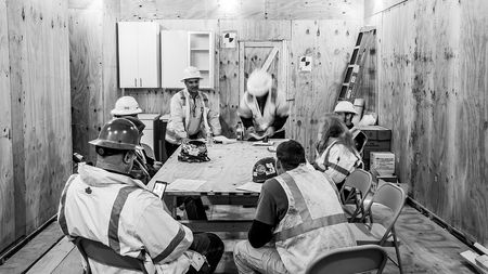 Black and white of construction team meeting
