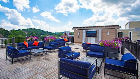 Rooftop seating options with ample seating, small tables with television