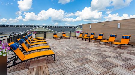 Rooftop lounging area with brightly colored chaise loungers