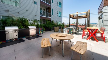 Exterior table and chairs near grilling stations