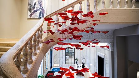Preserved Grand Staircase in main foyer with hanging art down the center