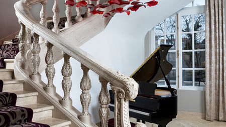 Grand Piano in Foyer with Large Window in Background