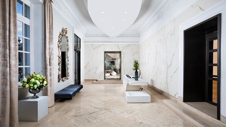 Grand lobby with travertine flooring and floor to ceiling windows