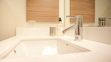 Close up view of modern sink and faucet within the bathroom