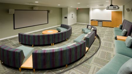 Theatre room with ample seating and large screen for viewing