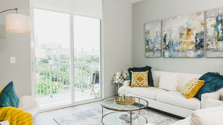 Living room with white sofa and blue and gold decor
