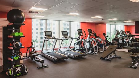Renovated fitness center with cardio and weight machines