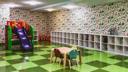Community children's room with toys and indoor playscape